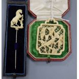 A carved ivory 'rearing horse' stick pin and a carved ivory panel pendant? 55mm.