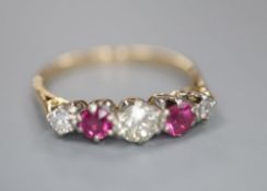 An early 20th century yellow metal and plat, three stone ruby and two stone diamond set half hoop