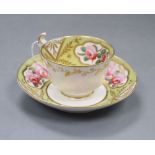 A Spode cup and saucer, painted with pairs of pink rose blooms