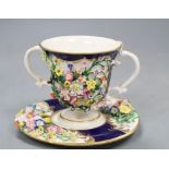 A Bloor Derby floral encrusted two handled cup and saucer, red printed factory mark