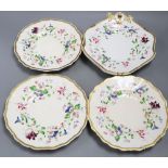 A set of three Staffordshire porcelain plates, gilt and painted with flowers and a matching pair