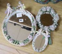 A Sitzendorf porcelain floral encrusted oval mirror and two smaller similar mirrors, tallest 33cm