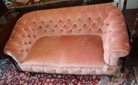 A small antique pink button back upholstered settee, width 140cm, depth 64cm, height 69cm