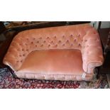 A small antique pink button back upholstered settee, width 140cm, depth 64cm, height 69cm