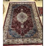 A Persian style burgundy ground small carpet 281 x 183cm