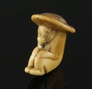 An 18th century Japanese stag horn netsuke of a monkey wearing a broad rimmed hat, depth 4cm