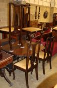 A 1920's oak gateleg dining table, W.150cm extended, together with a set of four Art Nouveau style