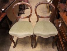 A part set of five Victorian mahogany balloon back dining chairs