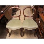 A part set of five Victorian mahogany balloon back dining chairs