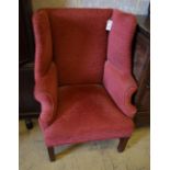 A George III style red dralon upholstered mahogany framed wing armchair