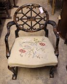 A painted and chinoiserie lacquered open armchair with pierced circular back and needlework seat,