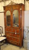 A French Empire style walnut and mahogany cabinet fitted mirror doors over three long drawers with