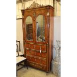 A French Empire style walnut and mahogany cabinet fitted mirror doors over three long drawers with