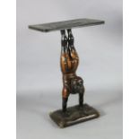 A 20th century carved and painted wood occasional table, with faux marble top, blackamoor acrobat