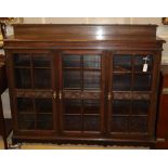 A 1920's carved oak three door bookcase, W.152cm, D.36cm, H.120cm