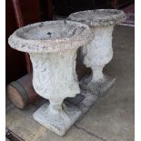 A pair of reconstituted stone garden urns, width approx. 36cm, height 51cm