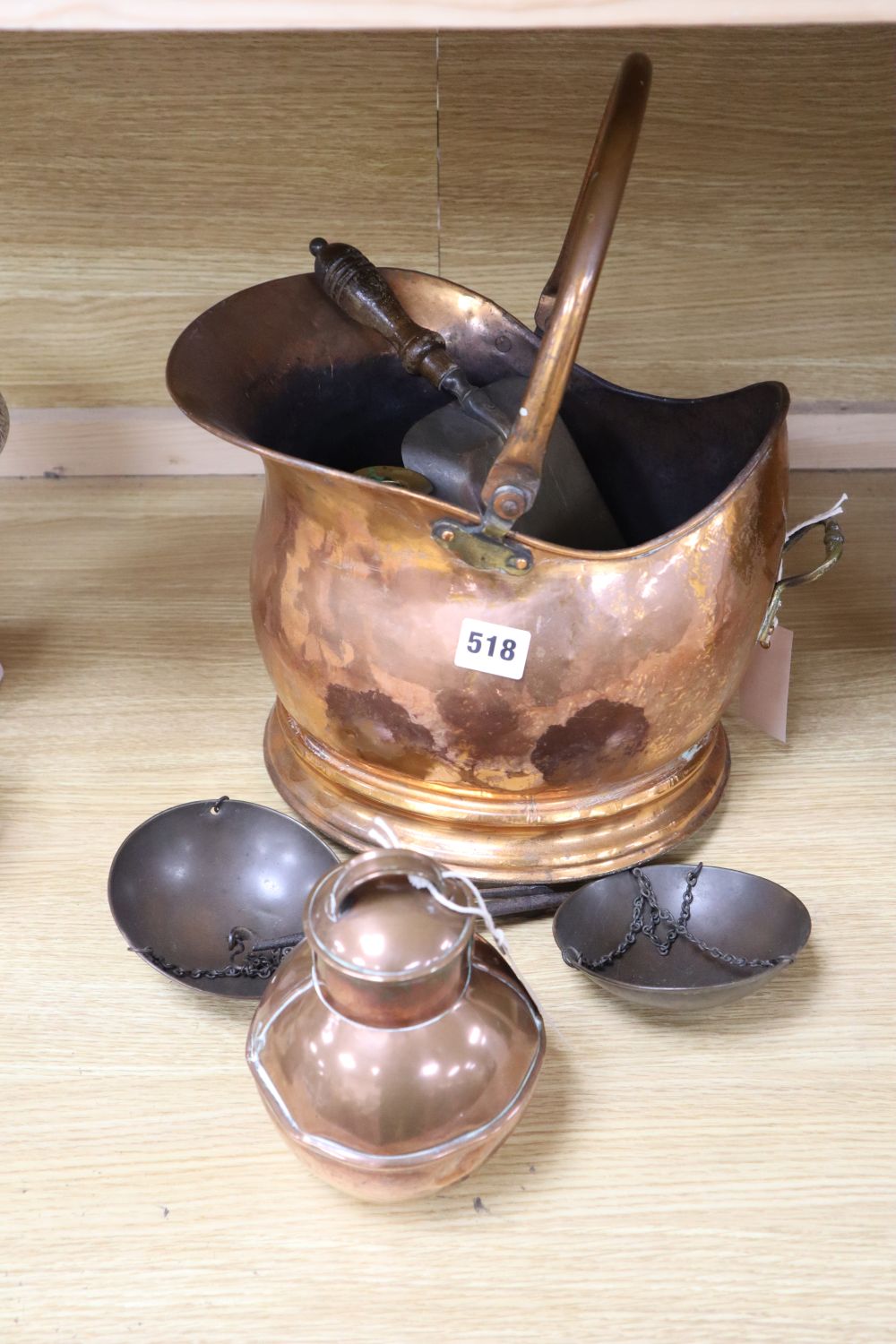 A copper coal, a pair of scales and a pair of 19th century brass pillar candlesticks