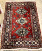 A Caucasian red and blue ground carpet, 158 x 108cm