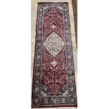 A Caucasian blue ground rug, 128 x 89cm, a Persian style red ground mat and a gold ground rug