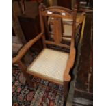 A pair of Arts and Crafts oak elbow chairs