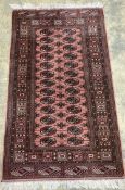 A Bokhara style pink ground rug, 103 x 93cm