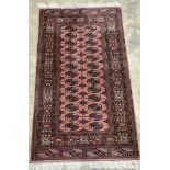 A Bokhara style pink ground rug, 103 x 93cm