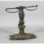 A Victorian cast iron stick stand, modelled as a terrier holding a riding crop, the oval base with