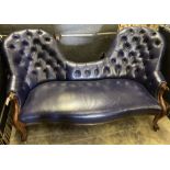 A Victorian mahogany double spoon back settee upholstered in dark blue button leather, width