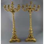 A pair of 19th century French ormolu six light candelabra, with scroll and mask branches, spiral