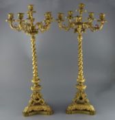 A pair of 19th century French ormolu six light candelabra, with scroll and mask branches, spiral