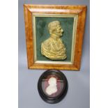 A maple framed ormolu relief of the Duke of Wellington and a plaster relief of Nelson, latter height