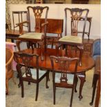 An early 20th century Chippendale revival mahogany dining suite comprising extending dining table
