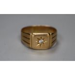 An 18ct and diamond chip set signet ring, size O, gross 5.1 grams.