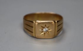 An 18ct and diamond chip set signet ring, size O, gross 5.1 grams.