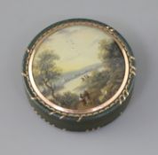 An early 19th century French bois durci snuff box, with gold inlaid decoration, the lid inset with a