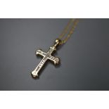 A 9k and diamond set gold cross pendant, on a 375 chain, pendant overall 31mm, gross 5.2 grams.