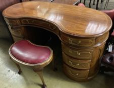 An Edwardian style mahogany kidney shaped dressing table, width 150cm, depth 64cm, height 77cm and