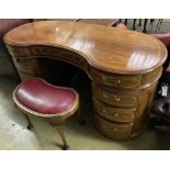 An Edwardian style mahogany kidney shaped dressing table, width 150cm, depth 64cm, height 77cm and