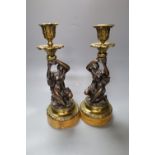 A pair of early 19th century gilt metal and bronze figural candlesticks, on marble plinths, height