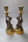 A pair of early 19th century gilt metal and bronze figural candlesticks, on marble plinths, height