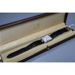 A gentleman's stylish silver gilt Dunhill quartz wrist watch, with Roman dial, on leather strap with