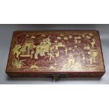A Chinese red lacquer box, gilded with figures and landscape, width 38cm
