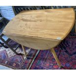 An Ercol light elm and beech circular drop leaf dining table, width 110cm, depth 127cm extended