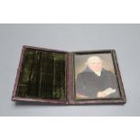 A mid 19th century portrait miniature of a seated gentleman, in folding frame, height 11cm