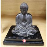 A Japanese Meiji period bronze Buddha, on stepped ebonised plinth, overall height 18cm