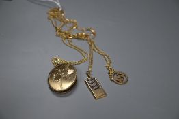 A 9ct gold locket on a 9k chain, and two other 375 pendants on 375 chains, gross 38.7 grams.