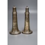 A pair of Victorian novelty silver pepperettes modelled as lighthouses, inscribed on each base '