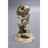 A fine 19th century Japanese ivory okimono of a fisherman startled by a fish, meiji period, height