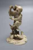 A fine 19th century Japanese ivory okimono of a fisherman startled by a fish, meiji period, height