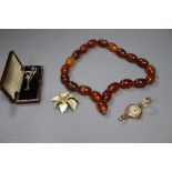 A faux amber bead necklace, a 9ct gold watch and costume jewellery.
